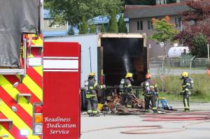 Firefighters spray the inside of a moving truck with water at the scene of a short vehicle fire on Sept. 17, 2020. (Ben Hohenstatt / Juneau Empire)
