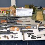 An Alaska man will appear in Canadian court on Sept. 21 after an incident entering Canada when border security officers seized the fourteen firearms pictured, alongside loaded magazines, ammunition, and other paraphernalia at a crossing southeast of Vancouver. (Courtesy photo / Canada Border Services Agency)