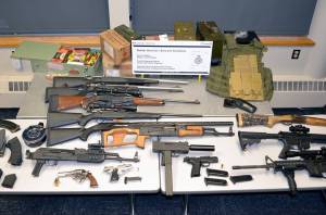 An Alaska man will appear in Canadian court on Sept. 21 after an incident entering Canada when border security officers seized the fourteen firearms pictured, alongside loaded magazines, ammunition, and other paraphernalia at a crossing southeast of Vancouver. (Courtesy photo / Canada Border Services Agency)