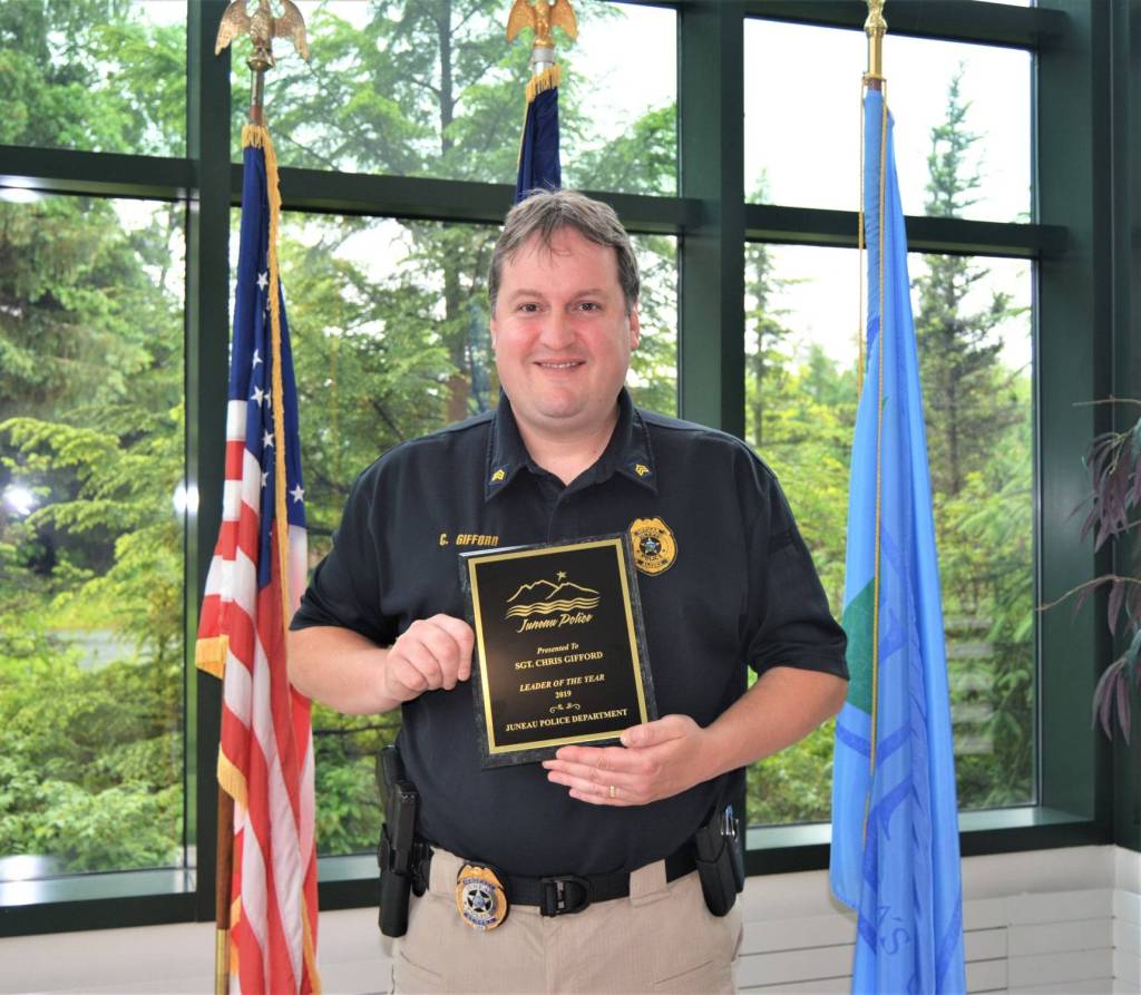 Sgt. Chris Gifford receives a plaque from Juneau Police Department Chief Ed Mercer naming her his choice for JPDs Leader of the Year, Sept. 18, 2020. (Courtesy Photo / Juneau Police Department)