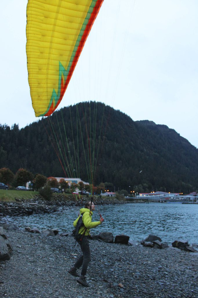 Nigel Krumdicek looks up while touching down near the channel on Sept. 22, 2020. (Ben Hohenstatt / Juneau Empire)
