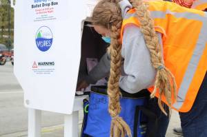 Deputy City Clerk Di Cathcart collects ballots from the ballot drop box at Don D. Statter Harbor the afternoon of Saturday, Sept. 19. Drop boxes located in Auke Bay and at the Douglas Public Library and Fire Hall are one of a few ways to vote in this years by-mail municipal election. (Ben Hohenstatt / Juneau Empire)
