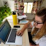 Kelly Mack works on her laptop to teach remotely from her early 1940s vintage camper/trailer in her backyard at home in Evanston, Ill. Across the U.S., the pandemic has forced students to attend virtual school to prevent spread of the coronavirus. But the more we rely on technology, the bigger the consequences when gadgets or internet service let us down. (AP Photo / Nam Y. Huh)