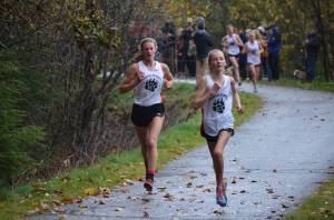 Courtesy photos / Debbie LowenthalAbove, Juneau-Douglas Yadaa.at Kalé High School students Rayna Tuckwood (right) and Skylar Tuckwood (left) race at the Thunder Mountain High School cross country race course during a regionals meet Oct. 3. Below, Juneau-Douglas Yadaa.at Kalé High School students Tim Degener (right) and Finn Morely (left) compete in the boys division.