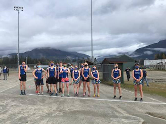 Mask-clad Thunder Mountain High School cross country runners stand together. Courtesy Photo / Sandi Pahlke