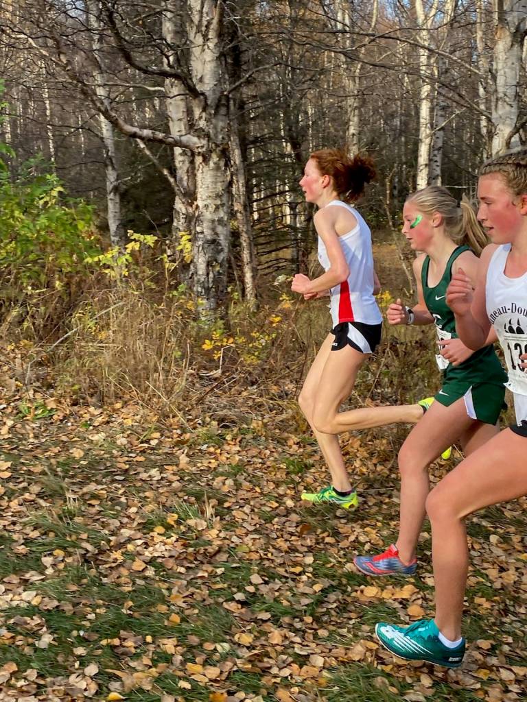 Juneau-Douglas Yadaa.at Kalé High School junior Annika Schwartz (leading) runs next to a Colony High school runner and JDHS freshman Iris White (trailing) during the state championship cross country meet on Oct. 10, 2020. (Courtesy photo / Emily Herman)