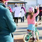 Alma Messing, 5, raises her fist during a womens march and rally held Saturday, Oct. 17 in Juneau. (Ben Hohenstatt / Juneau Empire)