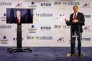 Al Gross, right, an independent in Alaskas U.S. Senate race, holds a document during a debate with Republican U.S. Sen. Dan Sullivan on Friday, in Anchorage. Sullivan participated remotely, as the Senate prepares to vote on President Donald Trumps Supreme Court nominee in Washington. (Jeff Chen / Alaska Public Media)