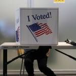 A voter fills out their ballot in person at the Mendenhall Valley Public Library on Oct. 6, 2020. The library was the site of one of the voting centers during the City and Borough of Juneaus by-mail municipal election. In the upcoming general election, Ballot Measure 2 will be on ballots in Alaska. (Ben Hohenstatt / Juneau Empire File)