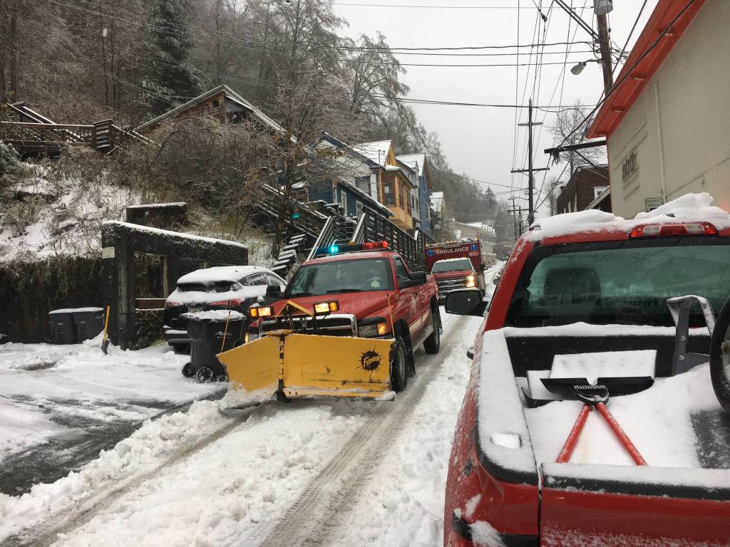 A Capital City Fire/Rescue truck clears the road ahead of an ambulance following a heavy winter storm on Nov. 2, 2020. (Michael S. Lockett / Juneau Empire)