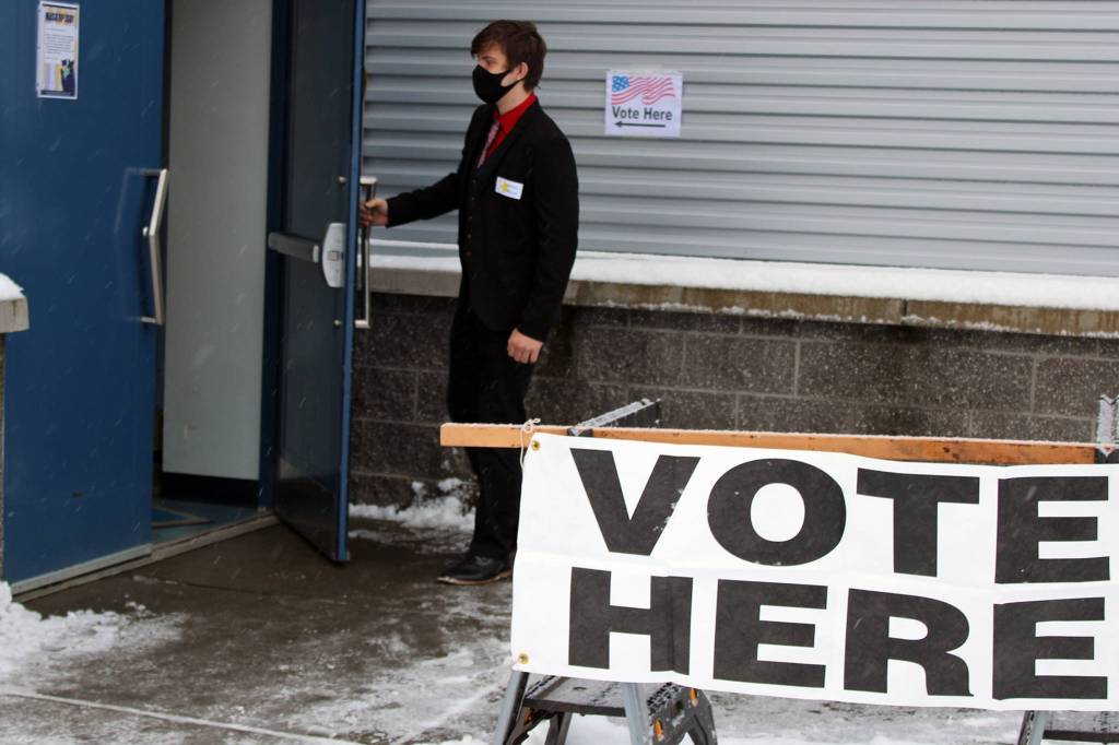 Election official James Zuiderduin walks into a polling place in Thunder Mountain High School. Zuiderduin, an 18-year-old home-schooled student, said he was working as an election official because the $15 per hour pay is attractive. Zuiderduin also voted during a lull in morning activity. This years election is the first presidential election in which he has been able to vote. What a presidential election to vote on, he said. (Ben Hohenstatt / Juneau Empire)