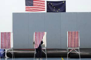 A voter fills out their ballot in the Thunder Mountain High School gymnasium on Tuesday, Nov. 3. Election officials said early turnout was steady but slightly slower than in past years--perhaps due to a surge in early voting within the precinct. (Ben Hohenstatt / Juneau Empire)