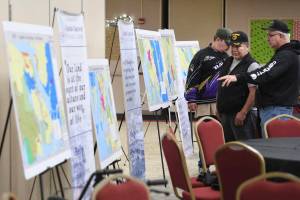 Jim Hoff, right, and Frederick J. Jackson, Sr. study maps during a presentation about communities left out of the Alaska Native Claims Settlement Act at Elizabeth Peratrovich Hall on Saturday, Dec. 14, 2019. Sen. Lisa Murkowski, R-Alaska, introduced legislation Tuesday which would recognize five additional villages in the Alaska Native Claims Settlement Act of 1971 (Michael Penn / Juneau Empire File)