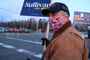 Republican U.S. Sen. Dan Sullivan waves a sign at a busy intersection in Anchorage, Alaska. Sen. Sullivan on Wednesday, Nov. 11, 2020, won reelection in Alaska, defeating independent Al Gross. (AP Photo / Mark Thiessen)