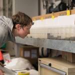 Steffi ODaly looks at sea water samples from Bering Strait aboard the UAF research ship Sikuliaq. (Courtesy Photo / Andrew McDonnell)