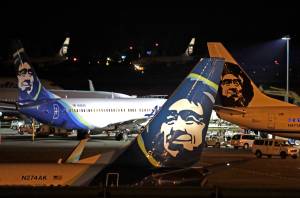 In this August 2018 photo, Alaska Airlines planes sit on the tarmac at Sea-Tac International Airport in SeaTac, Wash. Officials say an Alaska Airlines jetliner struck a brown bear while landing early Saturday evening, Nov. 14, 2020, killing the animal and causing damage to the plane. (AP Photo / Elaine Thompson)