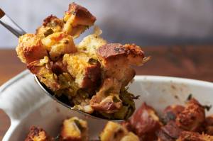 This August 2020 photo shows a recipe for traditional Thanksgiving stuffing in New York. The recipe can be cut in half and baked in a smaller pan for less time for a smaller group. (Katie Workman via AP)