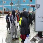 People wait in line for Thanksgiving meals at the Downtown Transit Center on Thursday, Nov. 26. (Ben Hohenstatt / Juneau Empire)