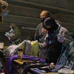 Kaitlyn Conway, youth outreach coordinator with the Zach Gordon Youth Center, talks to people who identified themselves as Vivian and Al, Saturday in the Marine Parking Garage. About 60 people had turned out to the event to provide on-the-spot assistance to people experiencing homelessness within its first hour, according to organizers. (Ben Hohenstatt / Juneau Empire)