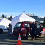 Health care workers help distribute flu vaccines to thousands of Juneau residents at Thunder Mountain High School on Saturday, Oct. 24, 2020. Local health authorities said the drive-thru clinic was a practice run for an eventual mass distribution of a COVID-19 vaccine. (Peter Segall / Juneau Empire)