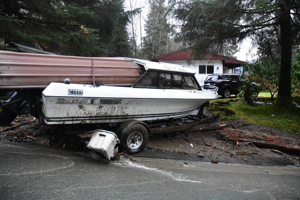 A mudslide caused by heavy rains Wednesday, Dec. 2, 2020, sent this boat crashing into a neighbors yard on Wire Street near Twin Lakes. (Peter Segall / Juneau Empire)