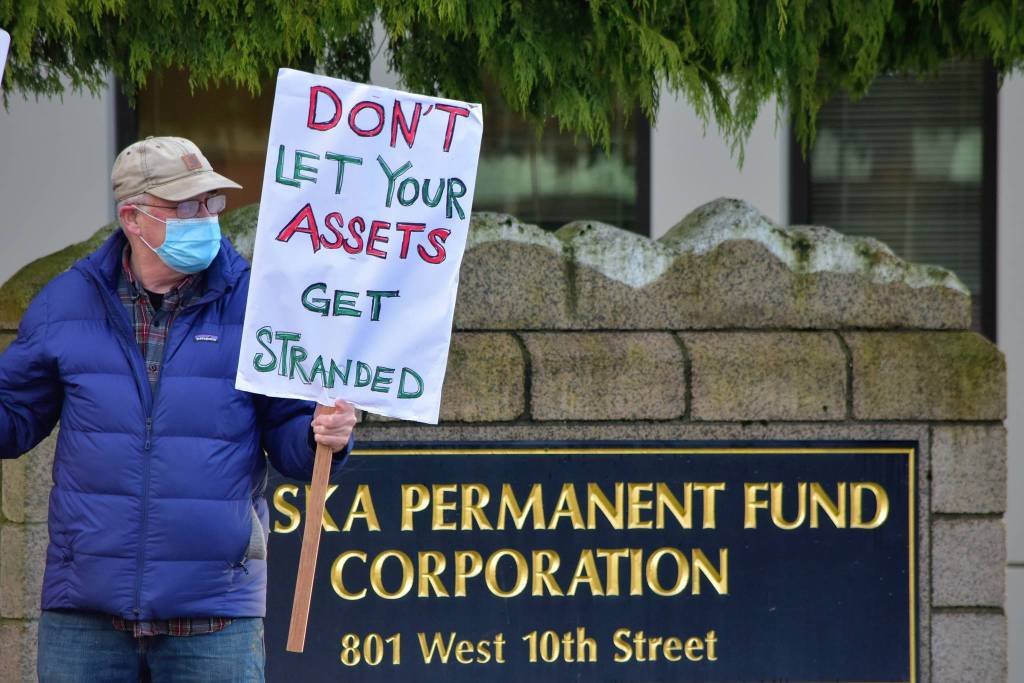 Peter Segall / Juneau Empire
Mike Tobin of environmental group 350Juneau demonstrates outside the Alaska Permanent Fund Corporation building on Wednesday. APFCs Board of Trustees were having their quarterly meeting inside and group members submitted testimony urging divestment from fossil fuels and other assets potentially impacted by climate change.