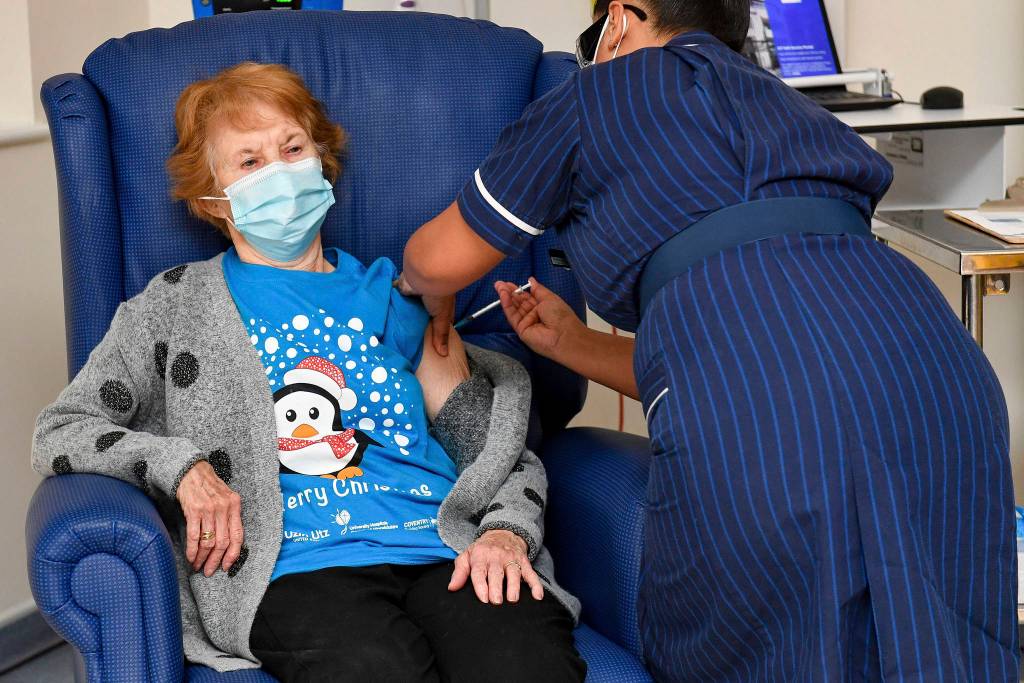 Jacob King/Pool via AP 
Margaret Keenan, 90, the first patient in the U.K. to receive the Pfizer-BioNTech COVID-19 vaccine, receives an injection by nurse May Parsons at University Hospital, Coventry, England.