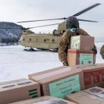 In this photo provided by the Alaska National Guard, soldiers from 1st Battalion, 207th Aviation Regiment, unload gifts from a CH-47 Chinook helicopter in Nanwalek, Alaska, during Operation Santa Claus, on Dec. 11, 2020. Operation Santa Claus is an Alaska National Guard annual community outreach program that provides Christmas gifts, books, school supplies and stocking stuffers to children in rural Alaskan communities. The Alaska National Guard and the Salvation Army were able to provide and deliver gifts for the programs 65th year, but had to scale back distribution parties that are normally held in the villages because of COVID-19. (Edward Eagerton / U.S. Army National Guard)