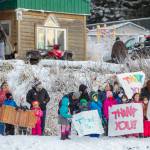 In this photo provided by the Alaska National Guard, residents of the village of Nanwalek, Alaska, greet guardsmen who delivered presents in a CH-47 Chinook helicopter from 1st Battalion, 207th Aviation Regiment, during Operation Santa, Dec. 11, 2020. The Alaska National Guard and the Salvation Army were able to provide and deliver gifts for the programs 65th year, but had to scale back distribution parties that are normally held in the villages because of COVID-19. (Edward Eagerton / U.S. Army National Guard)