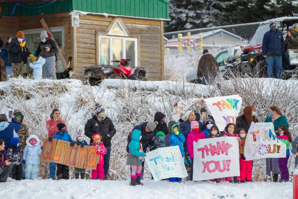 In this photo provided by the Alaska National Guard, residents of the village of Nanwalek, Alaska, greet guardsmen who delivered presents in a CH-47 Chinook helicopter from 1st Battalion, 207th Aviation Regiment, during Operation Santa, Dec. 11, 2020. The Alaska National Guard and the Salvation Army were able to provide and deliver gifts for the programs 65th year, but had to scale back distribution parties that are normally held in the villages because of COVID-19. (Edward Eagerton / U.S. Army National Guard)