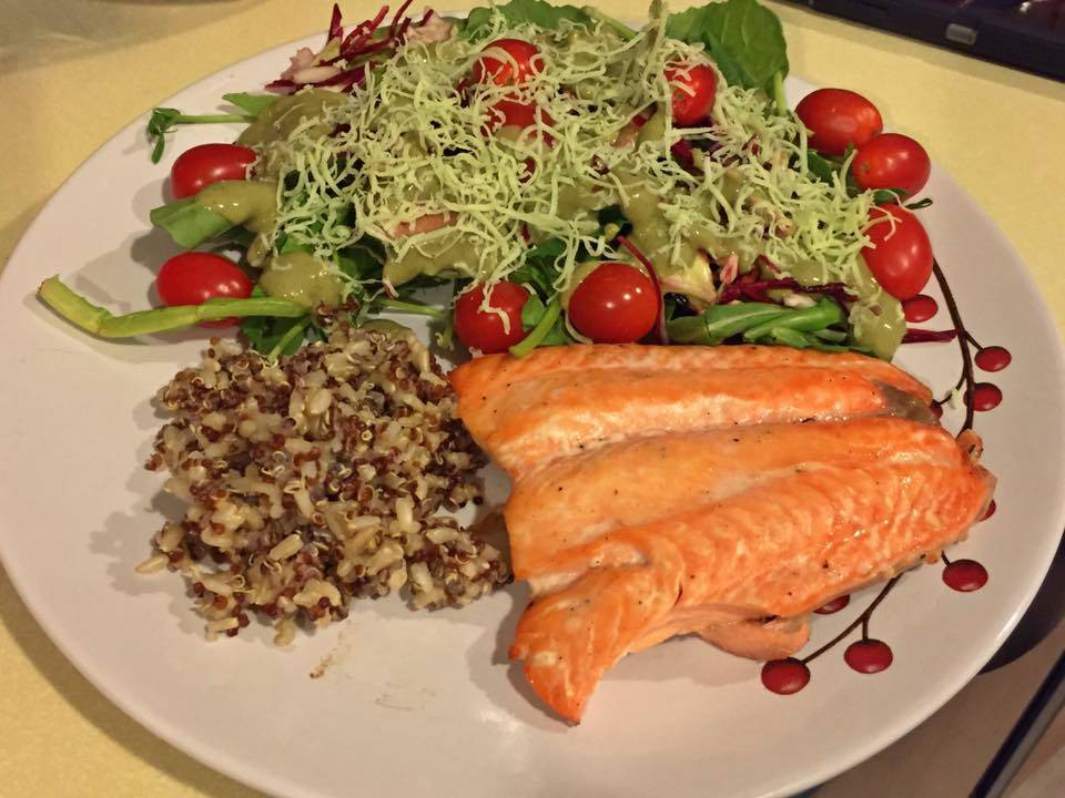 This photo shows salmon, quinoa and salad. (Vivian Mork Yéilk / For the Capital City Weekly)
