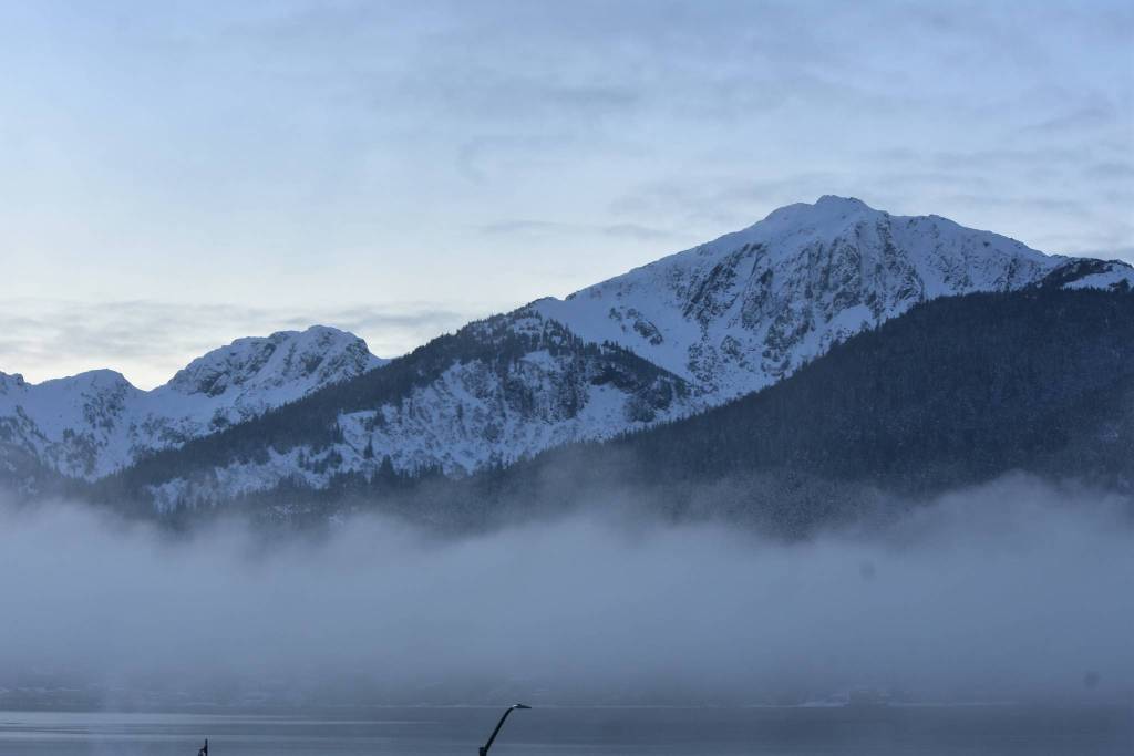 Peter Segall / Juneau Empire 
Douglas Island, within the Tongass National Forest, breaks through the morning fog on Dec. 15. A federal investigation found the U.S. Forest Service violated federal law in 2018 when it appropriated a $2 million grant to Alaska for input on Roadless Rule changes.
