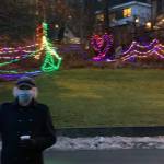 Bill Conrow, Juneau resident and long-time, free-lance stage director and light designer stands in front of a holiday light display near Juneau-Douglas City Museum. (Dana Zigmund / Juneau Empire)