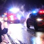 Ben Hohenstatt / Juneau Empire
Amaya Suckow,6, watches a police car and fire truck drive by during a holiday parade on Dec. 18.