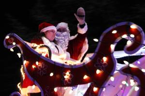 Santa Claus waves to Juneau residents who gatheredat a distanceto watch a holiday parade on Dec. 19. (Ben Hohenstatt / Juneau Empire)