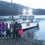 Curtis Jackson, second from right, poses on Thursday, Dec. 17, 2020, with SVT Heath & Wellness Center health care workers in Jakolof Bay, Alaska, after making a trip across Kachemak Bay from Homer to deliver the medical team and Pfizer COVID-19 vaccine. From left to right are nurse Candice Kreger, family nurse practitioner Kourtney Holder, Jackson, and family nurse practitioner Julie Drude. The health care workers then went by road to Seldovia. (Photo by Janel Harris courtesy of Mako's Water Taxi)