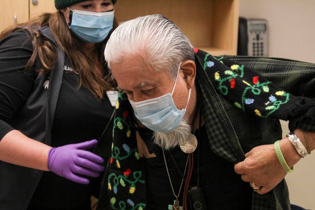 Michael S. Lockett / Juneau Empire
Southeast Alaska Regional Health Consortium nurse Courtney Taber helps Arsenio Pastor Credo as he prepares to receive the Moderna coronavirus vaccine at the Ethel Lund Medical Center on Dec. 24. Hes one of the first non-healthcare professionals to be vaccinated.