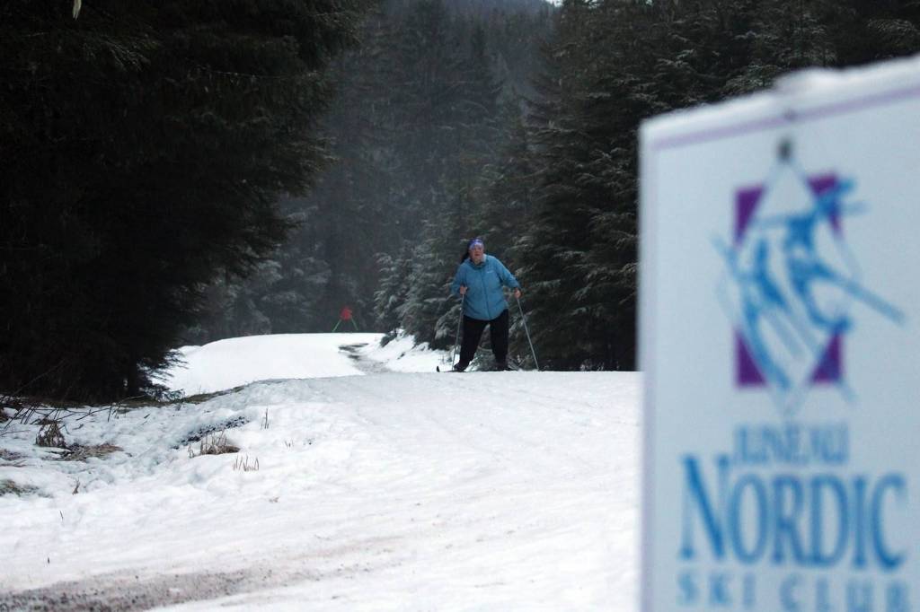 Allison Smith, a member of the Juneau Nordic Ski Club, passes another skier on her way along Montana Creek Road. Ski trails around Juneau will soon be hiding clues for Juneau Nordic Ski Clubs ski-ocache event. (Ben Hohenstatt/Juneau Empire)