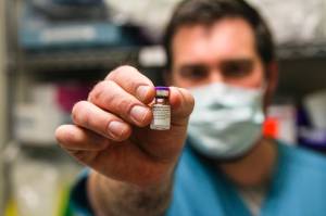Bartlett Regional Hospital pharmacist Chris Sperry holds a vial of COVID-19 vaccine on Dec. 15, 2020. BRH immediately began vaccinating its personnel upon receipt of the vaccine. (Michael S. Lockett / Juneau Empire)
