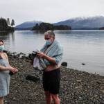 Sherri McDonald and Reid Tippets dry off after their annual dip in the water at Auke Recreation Picnic Area on New Years Day, Jan. 1, 2021. Tippets said hed done the dip for 11 years in a row. The Polar Bear Dip, held for 30 years at Auke Rec, was canceled this year over pandemic concerns, but some individual households opted to make the dip with their families, with masks, distancing, and care very much in evidence, while other pods had fires or walked dogs next to the cold ocean. (Michael S. Lockett / Juneau Empire)
