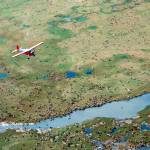 An airplane flies over caribou from the Porcupine caribou herd on the coastal plain of the Arctic National Wildlife Refuge in northeast Alaska. Conservationists will try to persuade a U.S. judge to stop the Trump administration from issuing leases to oil and gas companies in the Arctic National Wildlife Refuge. The Anchorage Daily News reported that the videoconference Monday, Jan. 4, 2021, in U.S. District Court in Anchorage is expected to determine whether the Bureau of Land Management can open bids in an online lease sale scheduled for Wednesday. The agency has offered 10-year leases on 22 tracts covering about 1,563 square miles in the coastal plain, which accounts for about 5% of the refuges area. (Courtesy Photo / U.S. Fish and Wildlife Service)