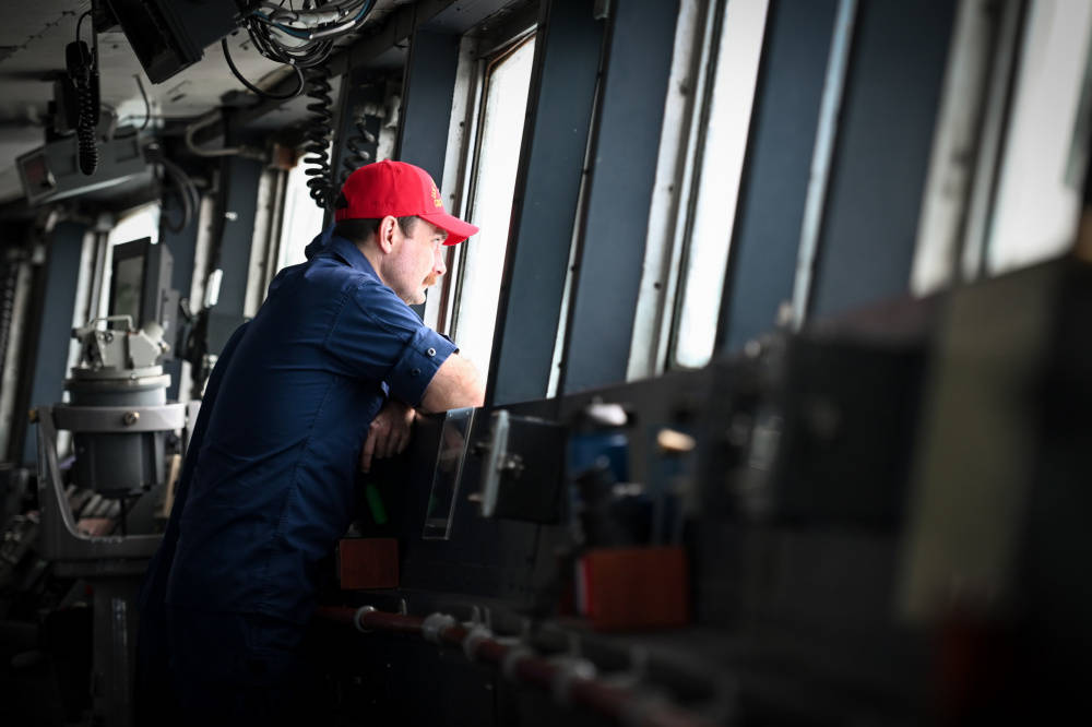 Capt. Bill Woityra, the commanding officer of the Coast Guard Cutter Polar Star looks out from the cutters bridge, Thursday, Dec. 17, 2020, while underway in the Bering Strait. The icebreaker is supporting an increasingly prioritized mission in the region, according the the Coast Guard. (Petty Officer 1st Class Cynthia Oldham / USCG)