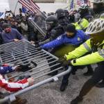 Trump supporters try to break through a police barrier, Wednesday, Jan. 6, 2021, at the Capitol in Washington. (AP Photo/John Minchillo)