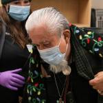 Southeast Alaska Regional Health Consortium nurse Courtney Taber helps Arsenio Pastor Credo as he prepares to receive the Moderna coronavirus vaccine at the Ethel Lund Medical Center on Dec. 24, 2020. The City and Borough of Juneau will be holding a clinic to vaccinate seniors and medical professionals at Centennial Hall, with registration beginning on Jan. 11, 2021. (Michael S. Lockett / Juneau Empire)