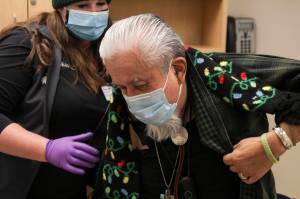 Southeast Alaska Regional Health Consortium nurse Courtney Taber helps Arsenio Pastor Credo as he prepares to receive the Moderna coronavirus vaccine at the Ethel Lund Medical Center on Dec. 24, 2020. The City and Borough of Juneau will be holding a clinic to vaccinate seniors and medical professionals at Centennial Hall, with registration beginning on Jan. 11, 2021. (Michael S. Lockett / Juneau Empire)