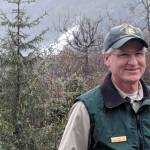 Then-Mendenhall Glacier Visitor Center Director John Neary smiles outside the visitor center, May 3, 2019. (Ben Hohenstatt / Juneau Empire File)