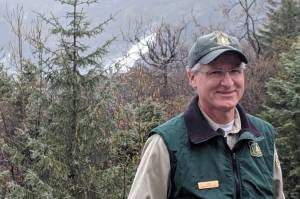 Then-Mendenhall Glacier Visitor Center Director John Neary smiles outside the visitor center, May 3, 2019. (Ben Hohenstatt / Juneau Empire File)