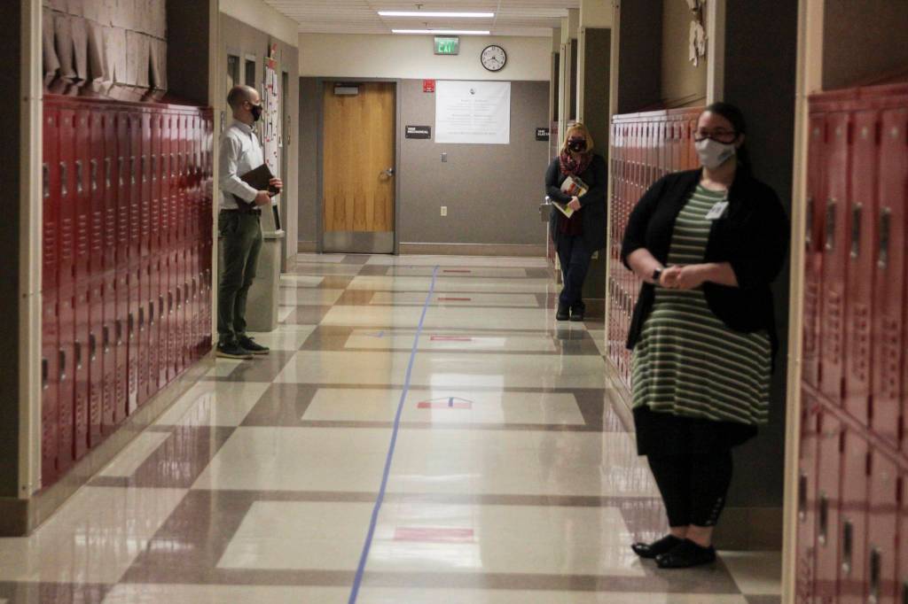 Teachers prepare to greet students as they reentered school Monday morning with distancing strategies and mitigation protocols in place at Floyd Dryden Middle School, Jan. 11, 2021. (Michael S. Lockett / Juneau Empire)