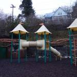 A child plays at Capital School Park. The park is in line for a remodel that will fix the crumbling retaining wall, visible in the background. (Dana Zigmund / Juneau Empire)