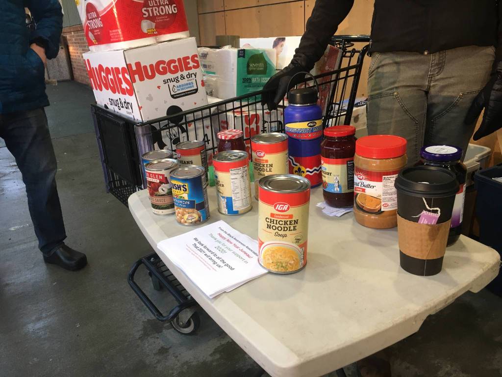 Volunteers and members of the Black Awareness Association of Juneau to help hold a food and childcare needs drive at several locations, including the Foodland IGA seen above, for Martin Luther King Jr. Day, Jan. 18, 2021. (Michael S. Lockett / Juneau Empire)